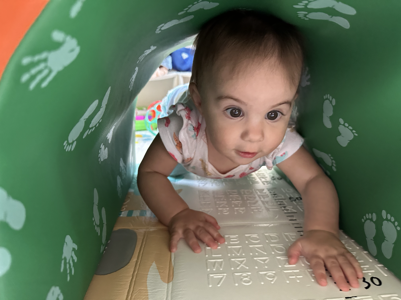 Zoe crawling through her foam tunnel.